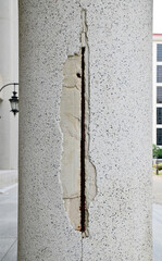 Close-up of The building's large cement pillars have cracks background for design and decoration at...