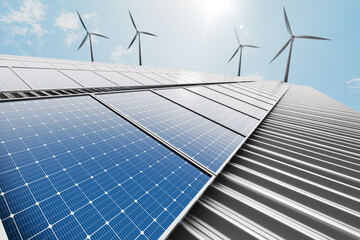 Solar panels mounted on a factory's metal sheet roof with a wind turbine in the background, set...