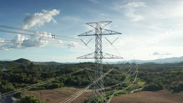 Transmission tower in aerial view. May called electricity pylon, steel utility pole consist of steel structure framing to support carry high-voltage cable or overhead power line for electrical grid.