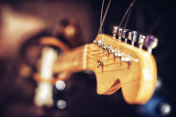 Closeup, guitar and music in studio for band, rehearsal and session to perform on stage, song and...