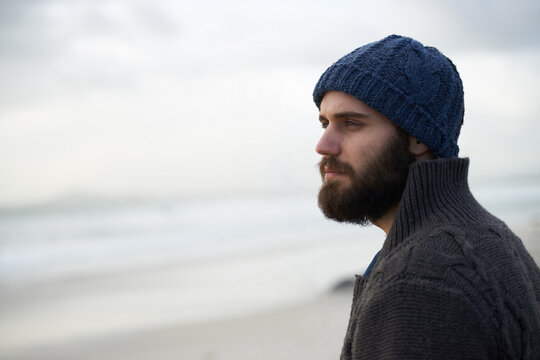 Thinking, calm and man at beach with memory, nostalgia or reflection with ocean view in nature. Remember, travel and male person at sea for fresh air, journey or peaceful Florida vacation in winter