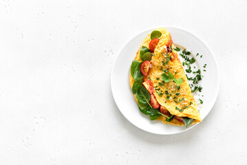 Stuffed omelette with tomatoes and spinach