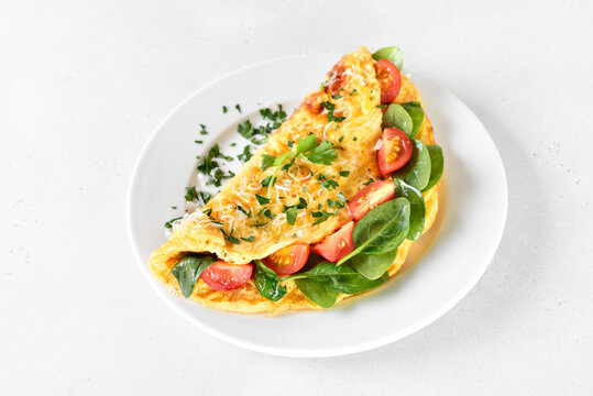 Breakfast omelette with spinach and tomato