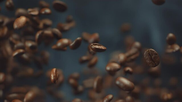 Super slow motion shot of falling roasted coffee beans with smoke in macro. Roasting flying coffee. Whole coffee explosion close up video