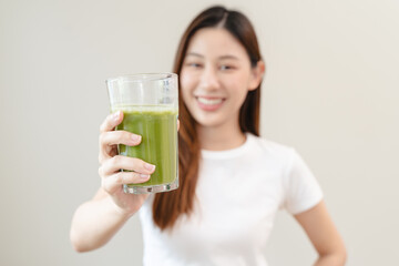 young woman drinking detox drink made by vegetable and fruit mixed.