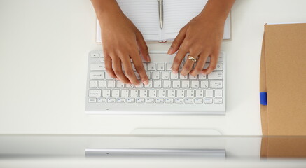 Fototapeta na wymiar Hands of a black woman on a computer keyboard, close-up. Online education, webinar, training courses