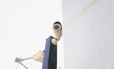 Outdoor surveillance camera on the building, close-up. Resident safety, electronic monitoring equipment