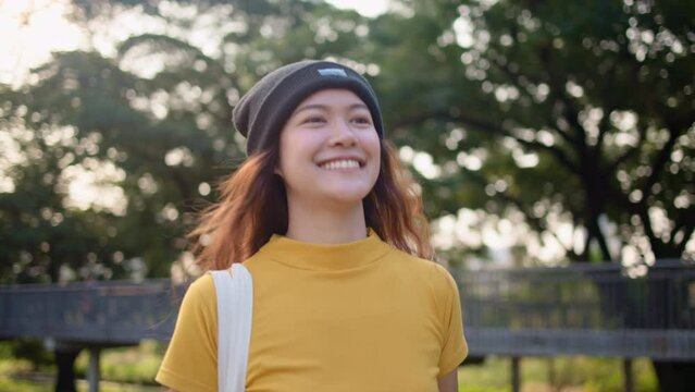 Go green Gen Z woman asia young people carrying eco tote mesh bag reuse walk in city nature tree public park save the earth planet world care. Reduce issues asian hope net zero waste the way forward.