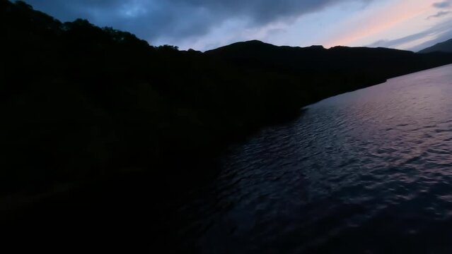Flying alongside the shores of Loch Lomond at dusk, Scotland.
