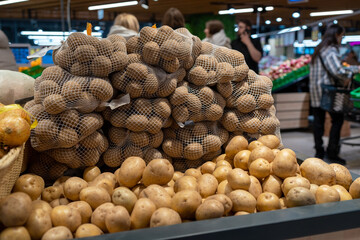 Closeup of fresh organic harvest potatoes on the supermarket shelf
