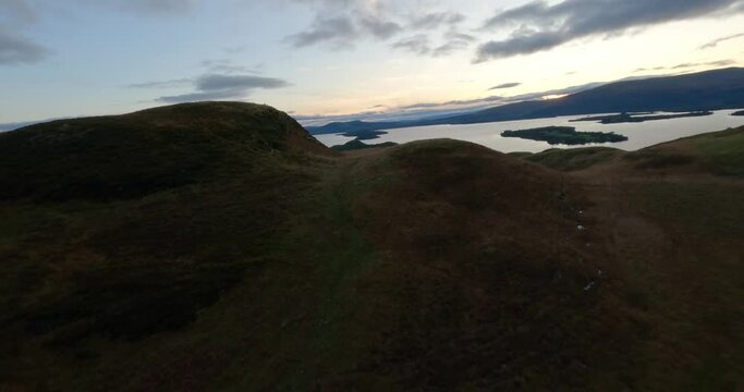 Aerial shot of Loch Lomond while flying over Conic Hill, Highlands, Scotland.
