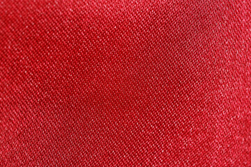 Close-up Texture of red polyester fabric with shine. Background for your design. Materials for...