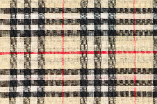 Kyiv, Ukraine - October 26, 2023: Texture close-up of Burberry tartan fabric in beige, black and red. Background for your design