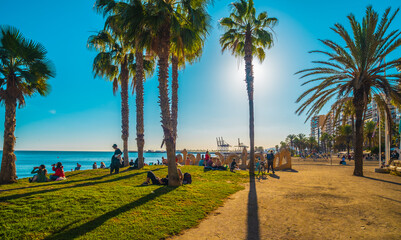 A view over La Malagueta beach in Malaga, Spain, with many people enjoying the good weather in a sunny day