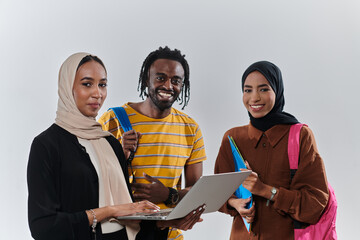 A group of students, including an African American student and two hijab-wearing women, stand...