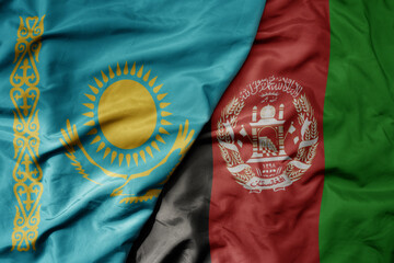 big waving national colorful flag of afghanistan and national flag of kazakhstan.