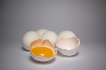 Close-up photo of white eggs on a white background, egg yolk in shell