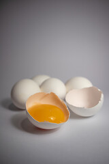 Close-up photo of white eggs on a white background, egg yolk in shell