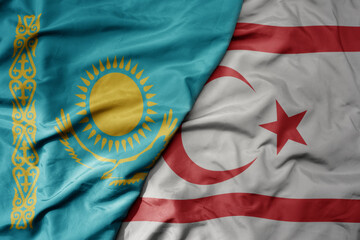 big waving national colorful flag of northern cyprus and national flag of kazakhstan.