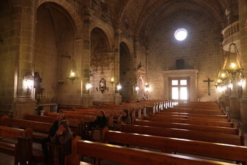 Castalla, Alicante, Spain, February 13, 2024: Faithful pray in the pews of the Church of Our Lady...