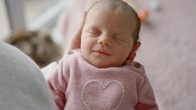 Solicitous Mother Gently Rocks Her Adorable Infant Baby Girl