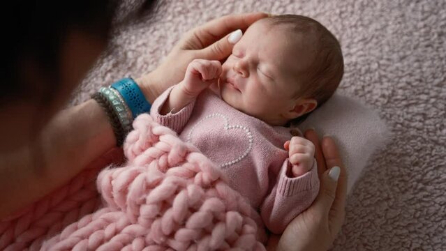 Solicitous Mother Gently Rocks Her Adorable Infant Baby Girl
