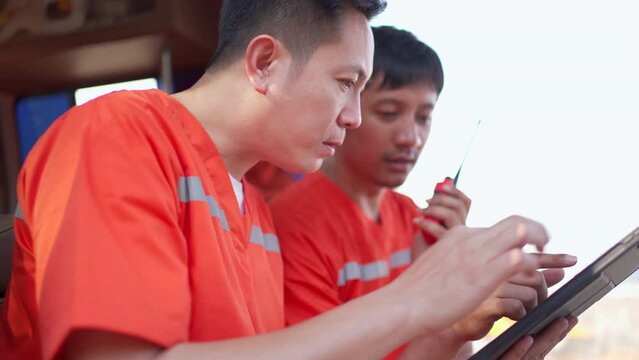 Emergency medical staffs reviewing a document on digital tablet.
