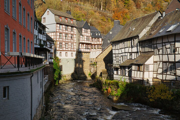 Fototapeta na wymiar Picturesque Monschau: Historic Buildings Along the Rur River in the Nordeifel