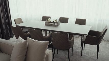 Modern ceramic long table with chairs in dining room