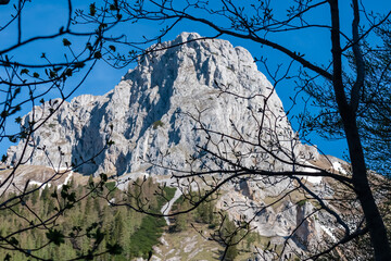 Panoramic view of majestic steep mountain peak Foelzstein in untamed Hochschwab mountain region, Styria, Austria. Scenic hiking trail on sunny day in remote Austrian Alps. Wanderlust in alpine summer