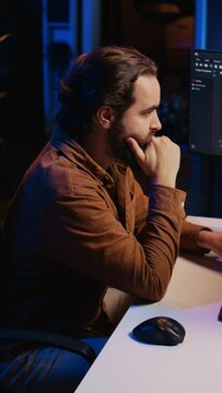 Computer engineer deliberating ways of fixing errors while developing code on PC. IT professional brainstorming ways of solving database errors, remotely working from home, camera B