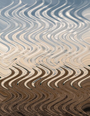 Fototapeta na wymiar Abstract pattern in brown and blue tones. Artistic zigzag image processing created by landscape photo. Beautiful multicolor pattern for any decor. Background image