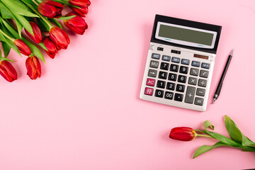 Business card mockup design with big financial calculator and bouquet of red tulips on pink...