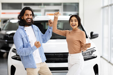 Indian Couple Celebrating Buying New Car, Dancing In Dealership Office