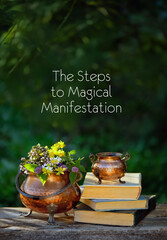 The Steps to Magical Manifestation. witch cauldrons with herbs, spell books on table outdoor, natural background. Magic Ritual, witchcraft. esoteric spiritual practice with sacred healing plants