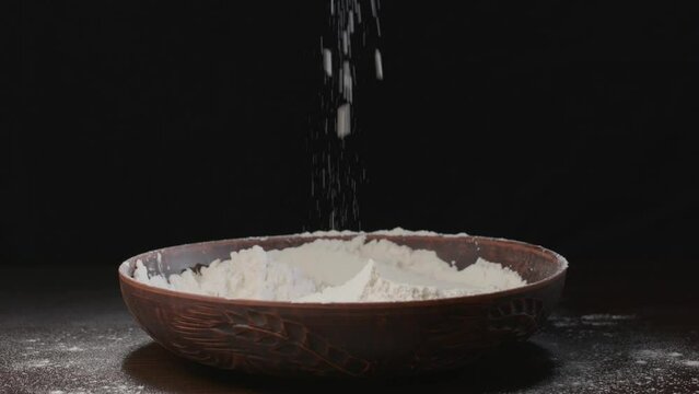 Men's hands pour white flour