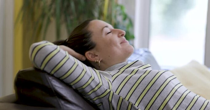 Authentic shot of young woman on the sofa relaxing and getting a nap