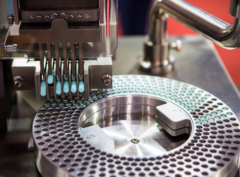 Capsule filling and packing machine in pharmaceutical manufacturing factory.