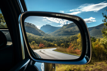 a zoomed or close-up image of a car front mirror with a beautiful view of Landscapes