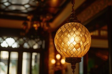 Obraz premium A simple and elegant ceiling light fixture hanging from the ceiling in a room. This image can be used to showcase interior design, home decor, or lighting concepts