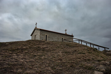 Chapel in a hill against cloudy sky