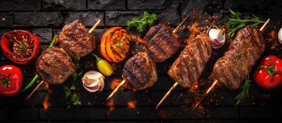 Deurstickers minced meat cutlet burgers on a BBQ grill steel grilled meat burger mix kebab meat Kebab adana chicken lamb and beef banner menu recipe place for text top view. Creative Banner. Copyspace image © HN Works
