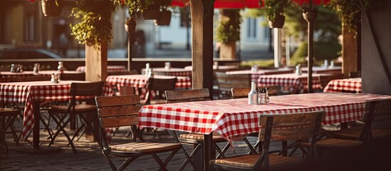Outdoor Italian Restaurant with Red Plaid Tablecloths Cozy Design. Creative Banner. Copyspace image - obrazy, fototapety, plakaty
