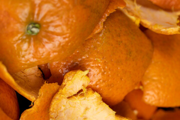 a large number of orange citrus fruits on a black slate surface