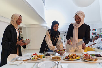 Group of young Arab women come together to lovingly prepare an iftar table during the sacred Muslim...