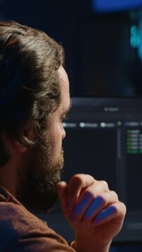 Software engineer puzzled in front of computer screen while writing complex code. Admin feeling confused while trying to fix database errors while working from home, camera A close up