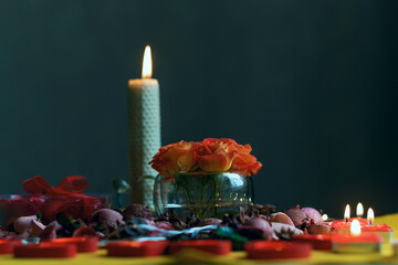 Bouquet of roses, candles and gifts, card for February 14, St. Valentine, March 8, wedding, birthday, mother's day, blurred background, bokeh.