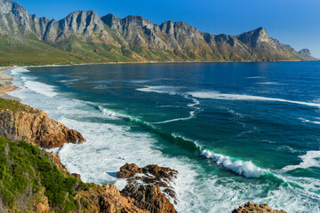 Glorious view of the Kogelberg mountains across False Bay along Clarence Drive between Gordon's Bay and Rooi-Els near Cape Town, Western Cape. South Africa. - obrazy, fototapety, plakaty