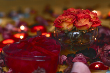 Bouquet of roses, candles and gifts, card for February 14, St. Valentine, March 8, wedding, birthday, mother's day, blurred background, bokeh.