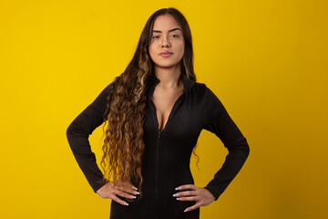 Sexy woman with long curly hair wearing a black textured outfit